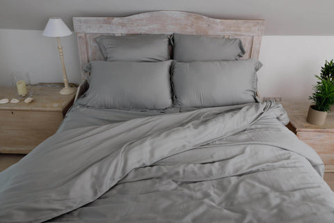 Eucalyptus silk sheet set on bed in grey