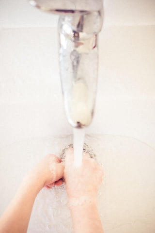 hands in wash basin