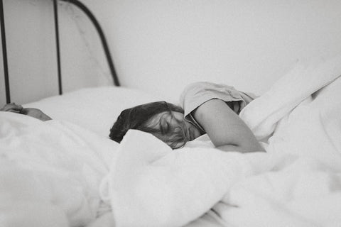 person sleeping in white bed