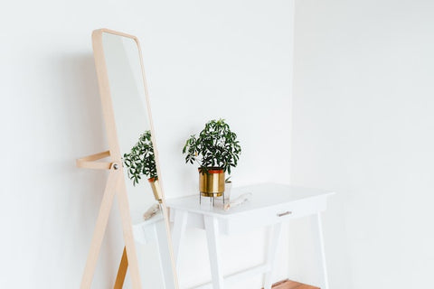 wooden standing mirror in bedroom