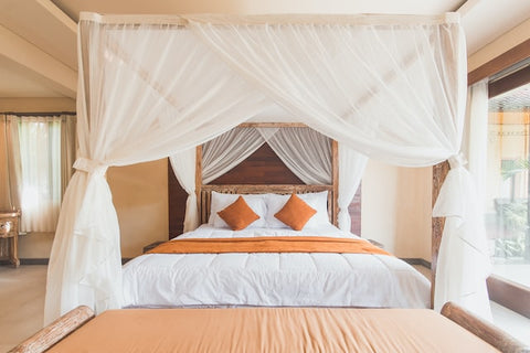 large bed with white canopy