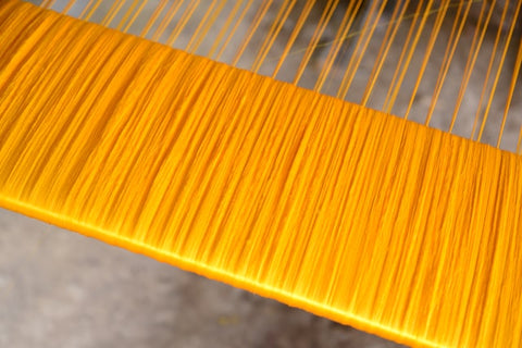 yellow silk being manufactured