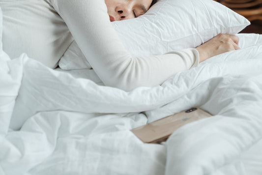 lady sleeping in white bed sheets