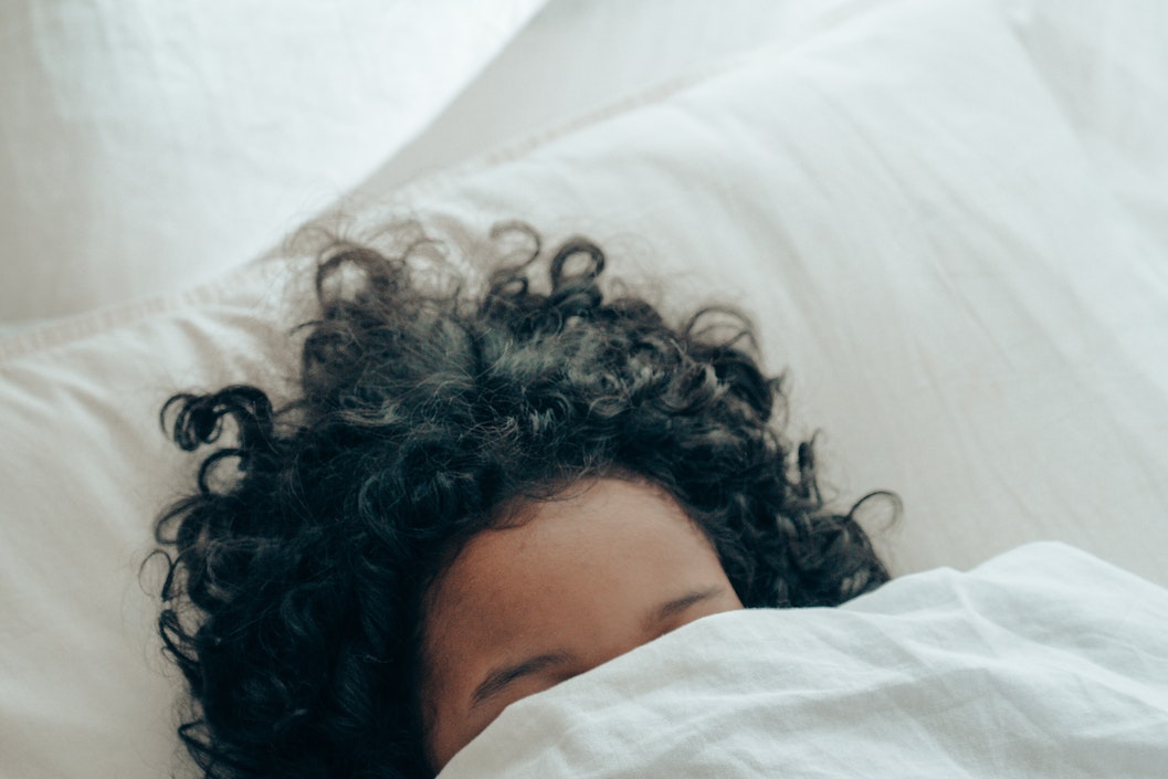 sleeping woman underneath a duvet