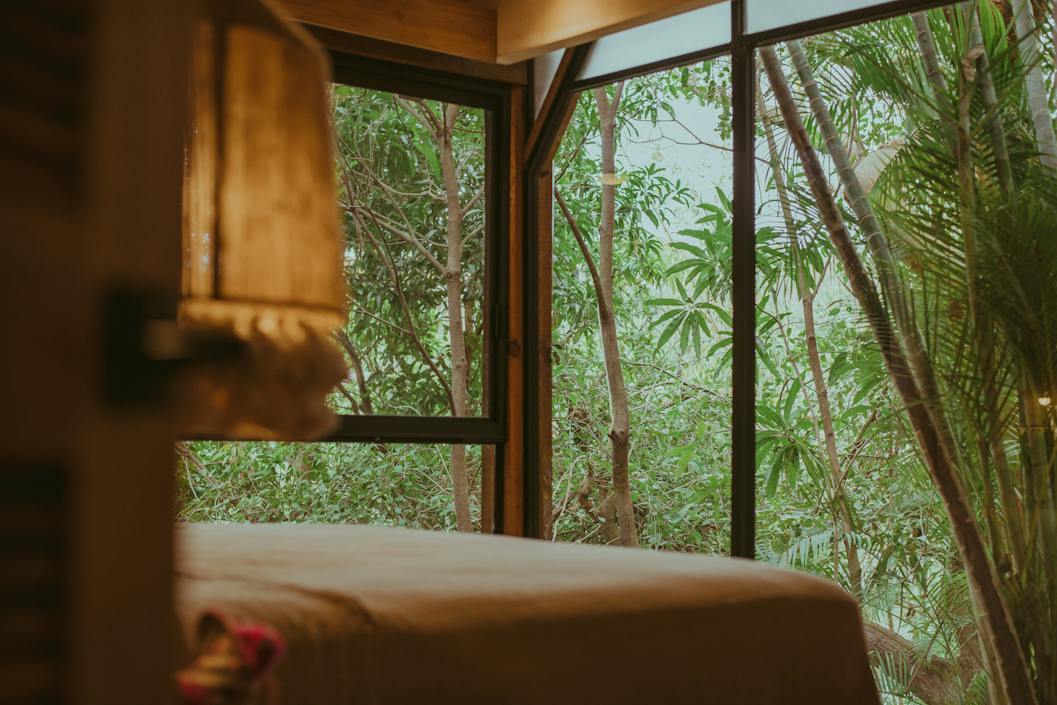 dark bedroom with trees in the view