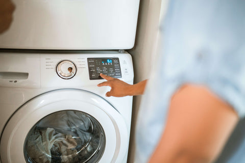 washing machine man pressing settings