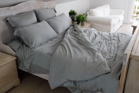 ethical bedding bed sheets on bed in grey